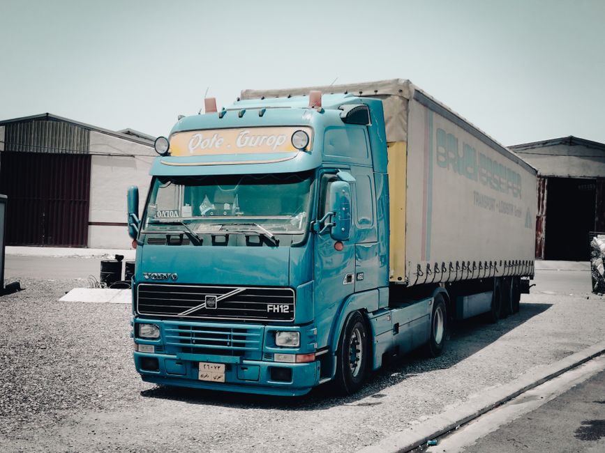Movers carefully loading heavy furniture into a moving truck